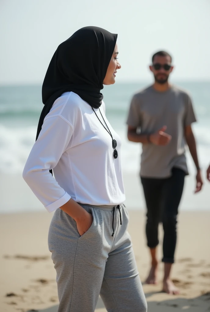 with black headscarf, white long sleeve t shirt, grey sweatpants, barefoot, skinny and short woman talking with friends on the beach. 