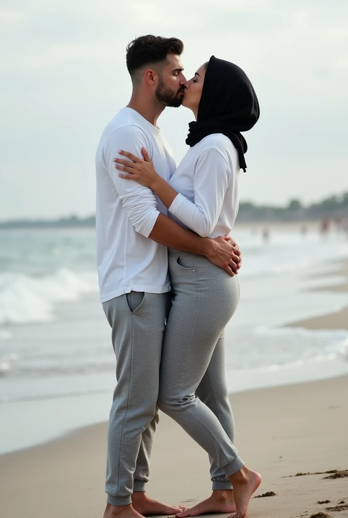 Black headscarf on the beach, black sweatpants, barefoot, white long sleeve t shirt, Sexy skinny woman. Man kneeling in front of woman. Woman puts her foot on the front of man's sweatpants.