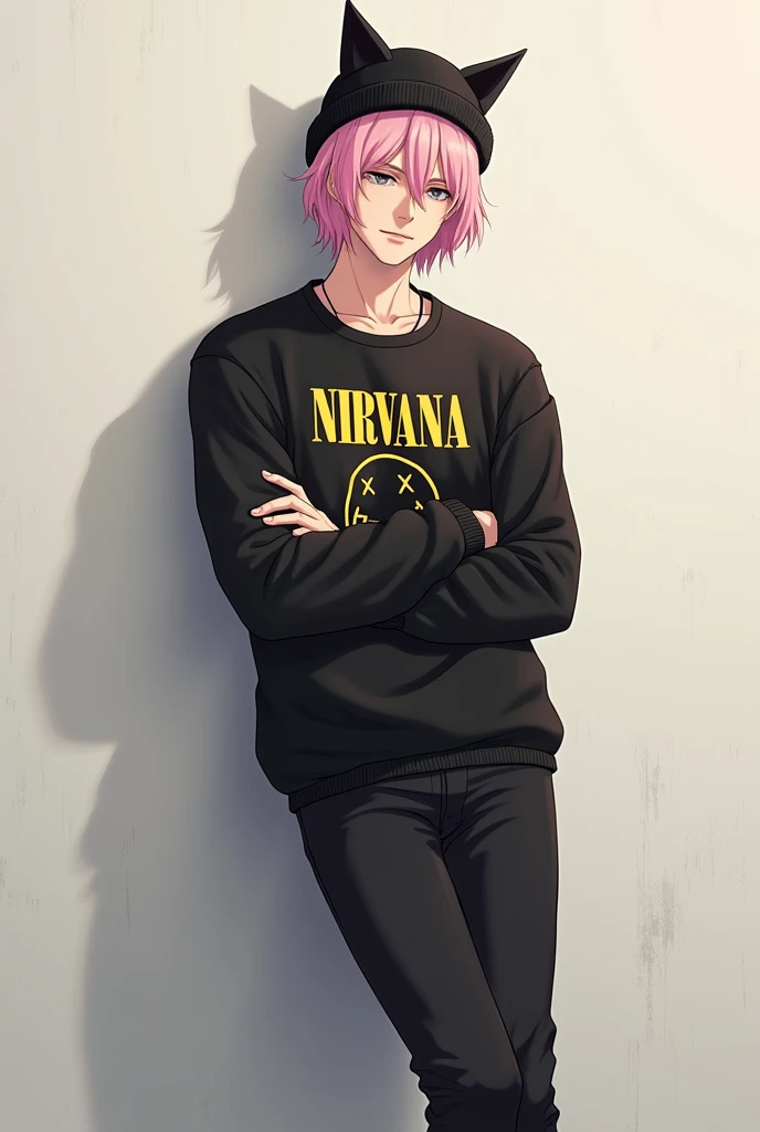 Man with medium short pastel pink hair wearing a black sweater that says Nirvana and black pants with a hat with black cat ears also with his arms crossed leaning against a wall