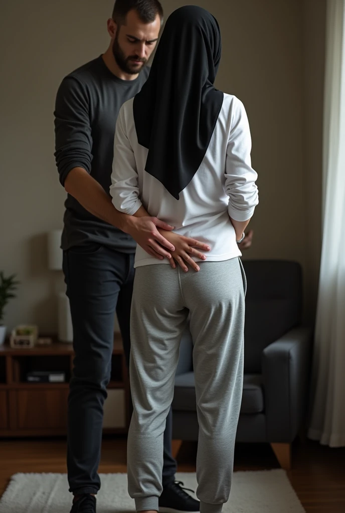Black headscarf at home, white long sleeve t shirt, grey sweatpants, white socks, woman without shoes. Men touching women's .
