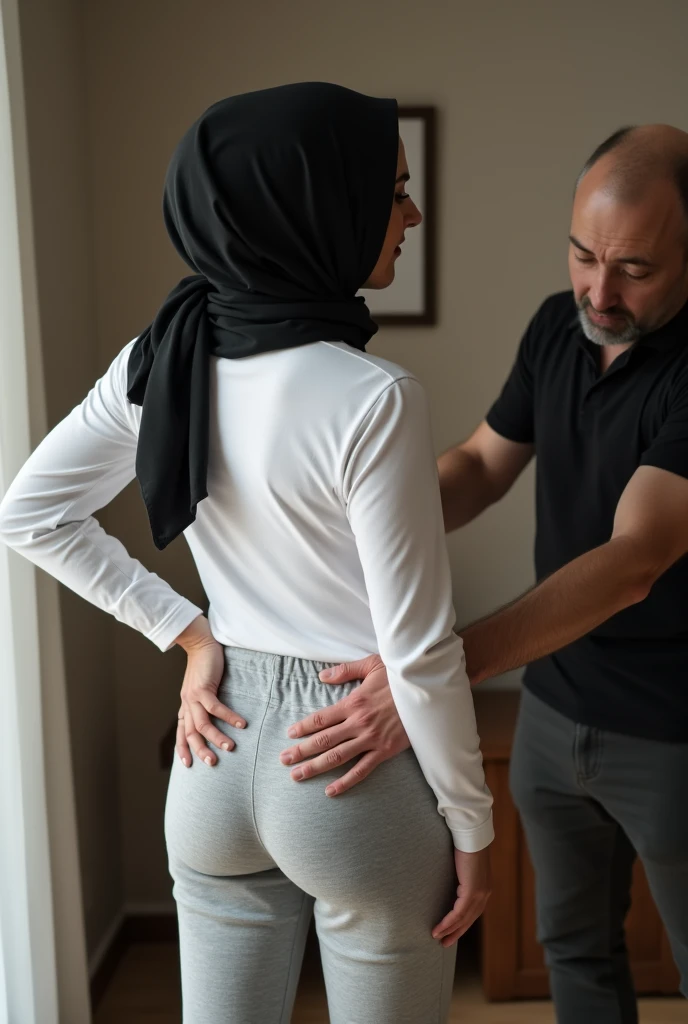 Black headscarf at home, white long sleeve t shirt, grey sweatpants, white socks, sexy woman without shoes. Men touching women's buttocks
