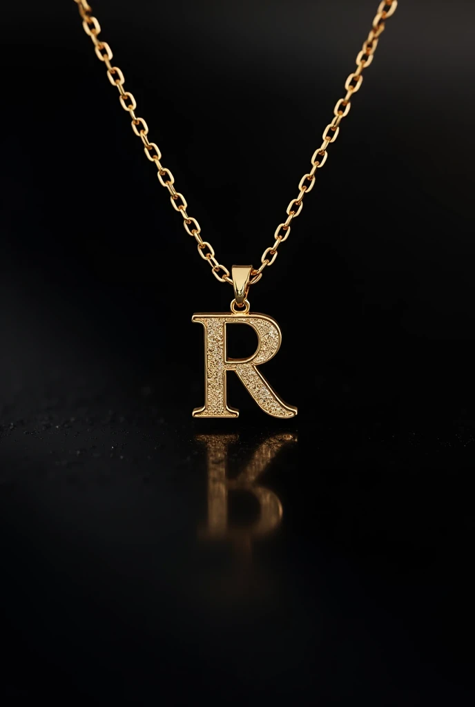 A gold necklace on a black screen with R written on it