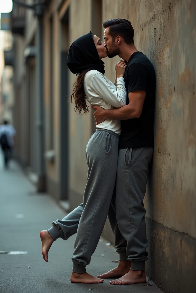 with black headscarf, white long sleeve t shirt, baggy grey sweatpants, barefoot sexy skinny woman. Man kissing woman with her back against the wall on the street.