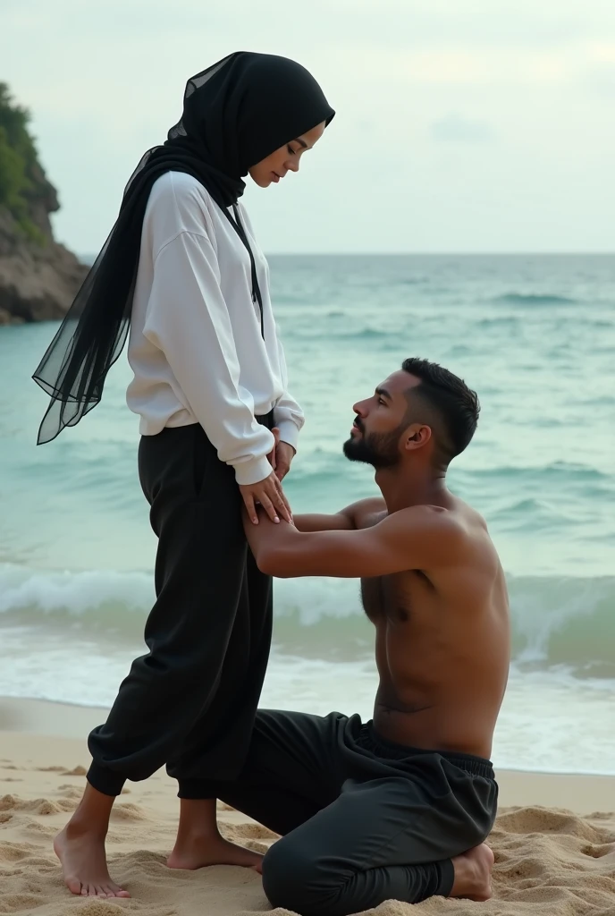 Black headscarf on the beach, white long sleeve t shirt, baggy black sweatpants, barefoot, Sexy skinny woman. Man kneeling in front of woman, Woman touching the front of man&#39;s sweatpants with her foot.