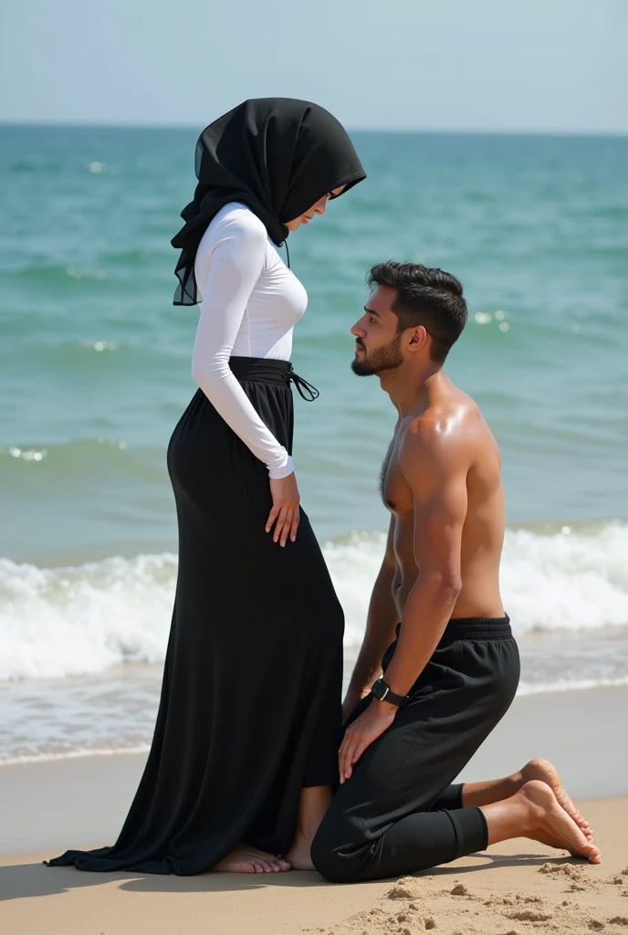 Black headscarf on the beach, white long sleeve t shirt, black long skirt, barefoot, Sexy skinny woman. Man kneeling in front of woman, Woman touching the front of man&#39;s sweatpants with her foot.