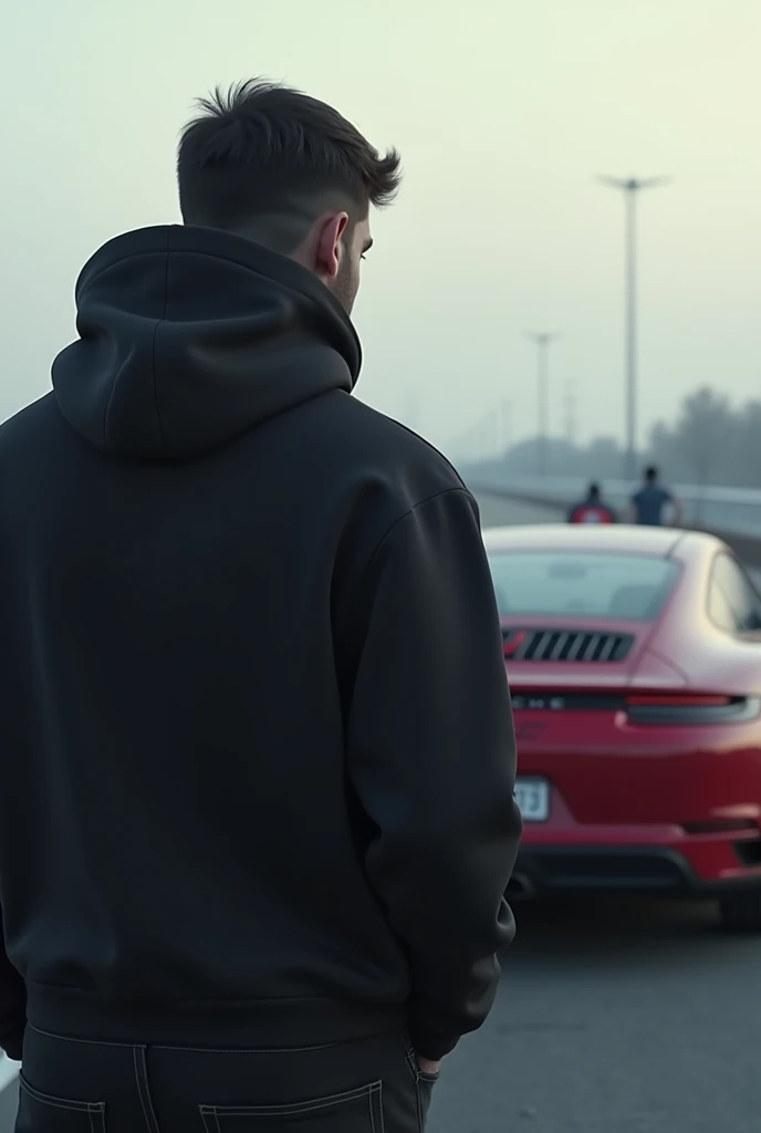 a man with his back turned and in front of him a porshe gt3 the man with a black hooded sweatshirt on his head 