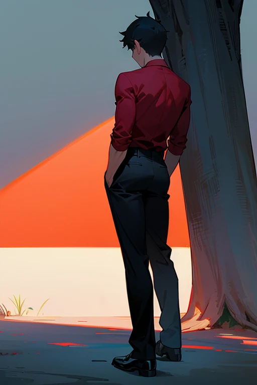 A young man with his back turned in a red shirt and black pants looks at the shadow of a tree in the park