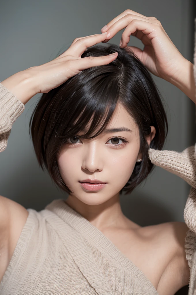 A short haired woman who messes up her hair with her hands