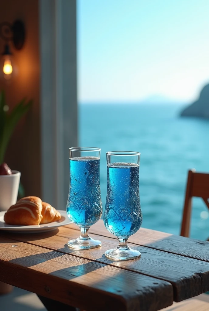 Blue drink in fancy glasses on a wooden table, in a bakery overlooking the sea.