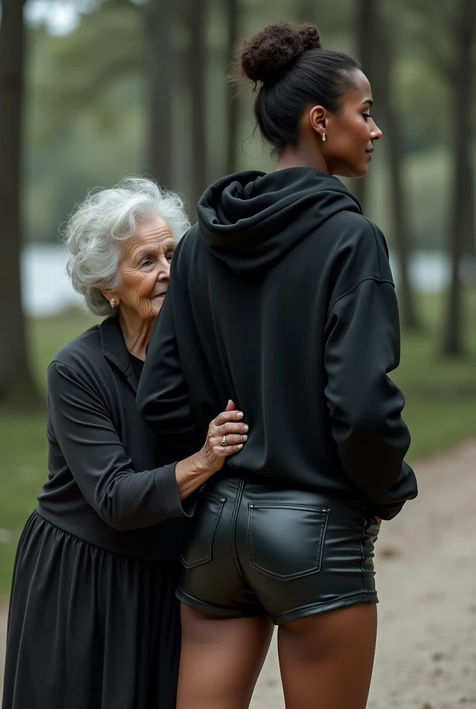 black woman hair in a bun black hoodie black leather short shorts being fucked in the ass by a old grandma in a dress