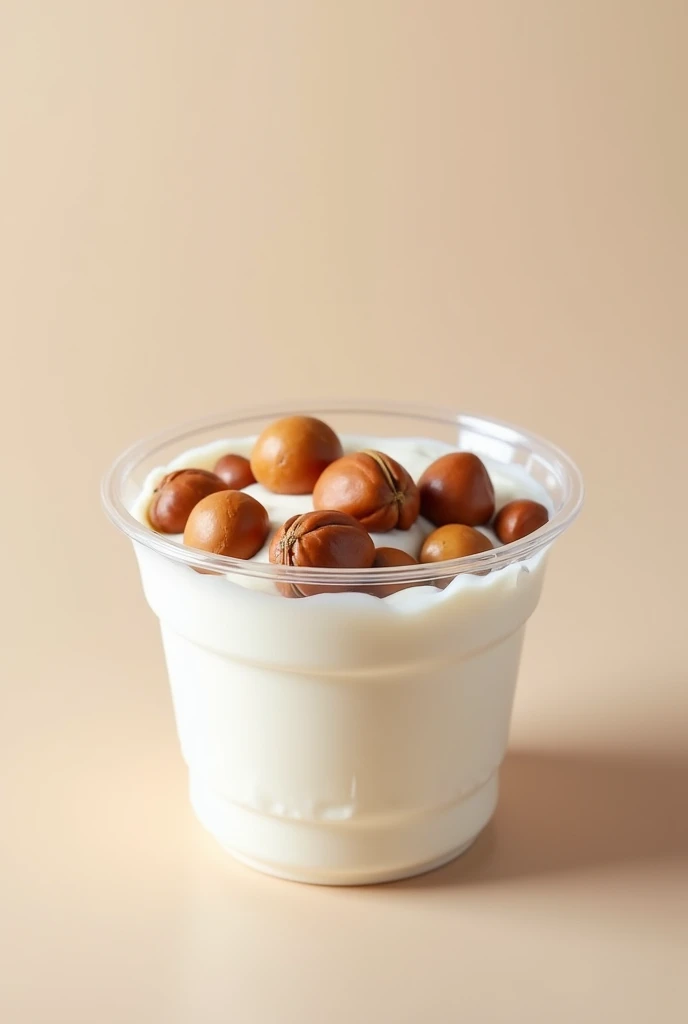 Greek yogurt container with clear plastic lid with hazelnuts inside it
