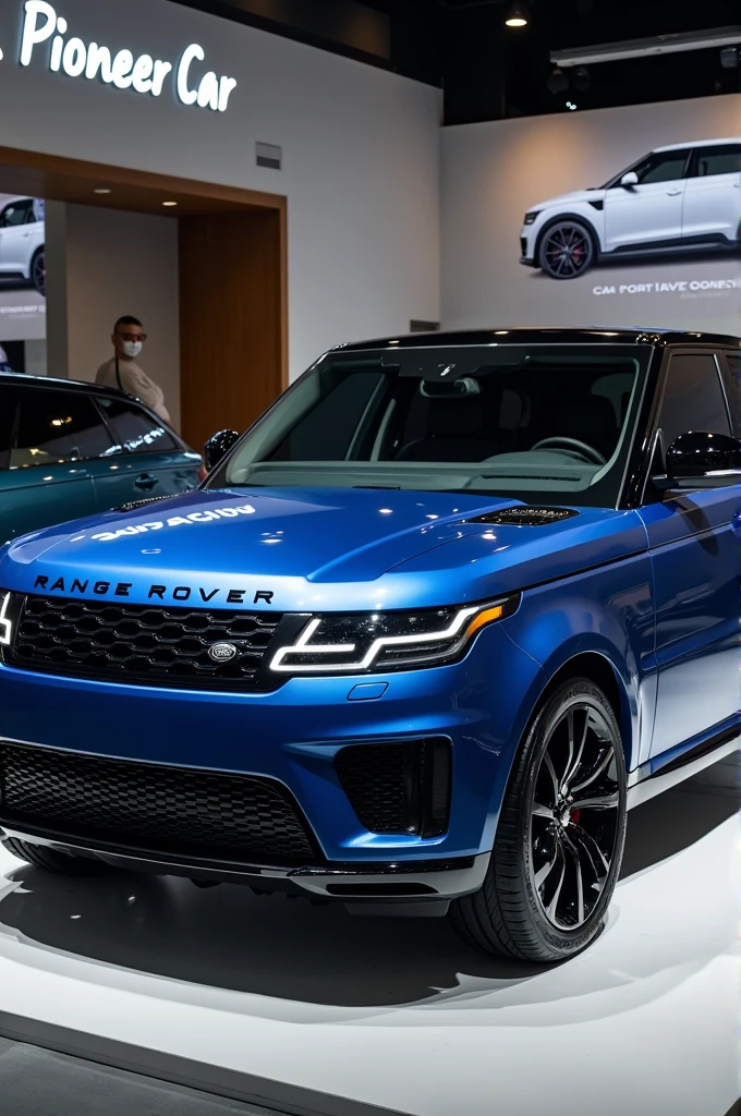 A metallic blue Range Rover parked with the background showing a sign that reads 'pioneer car.' The car is displayed in a well-lit environment, highlighting its sleek design and glossy finish."