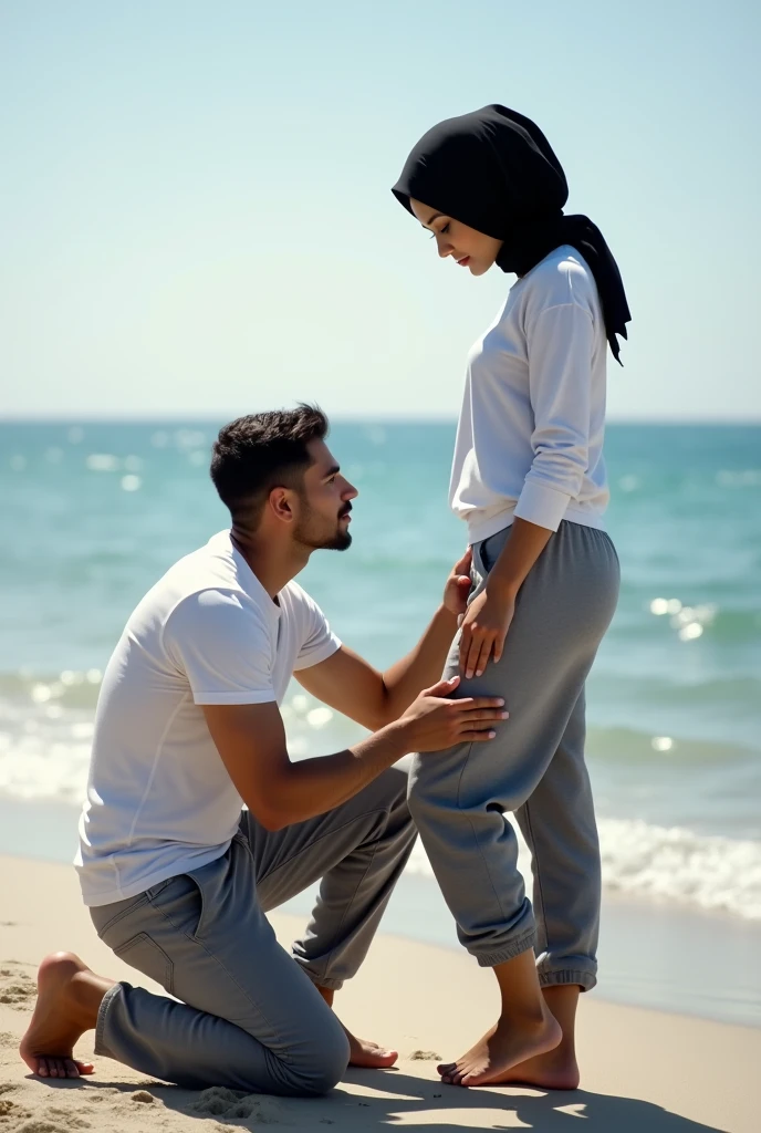 Black headscarf on the beach, white long sleeve t shirt, baggy grey sweatpants, barefoot, Sexy skinny woman. Man kneeling in front of woman, Woman touching the front of man's sweatpants with her foot.