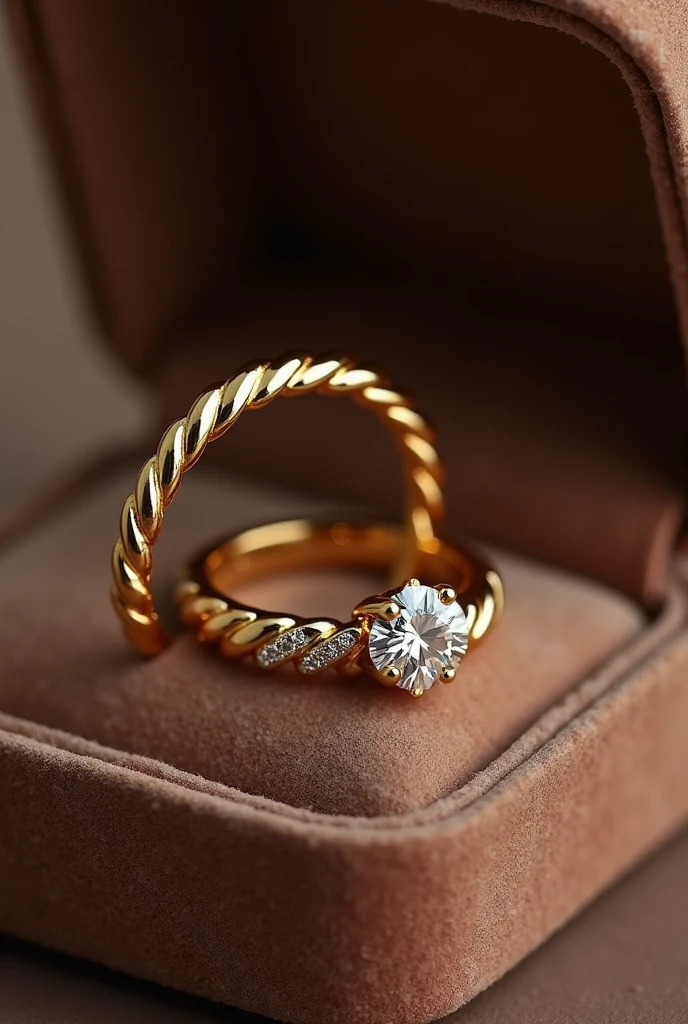 pair of wedding rings and engagement ring in gold color in a velvet box the men's ring is simple, only smooth and matching the women's ring in a soft braided pattern the women's ring has a brilliant minimalist diamond stone reminiscent of a flower with petals and around it a braided finish with small diamonds Inside the rings is written the word "AKAI TO"