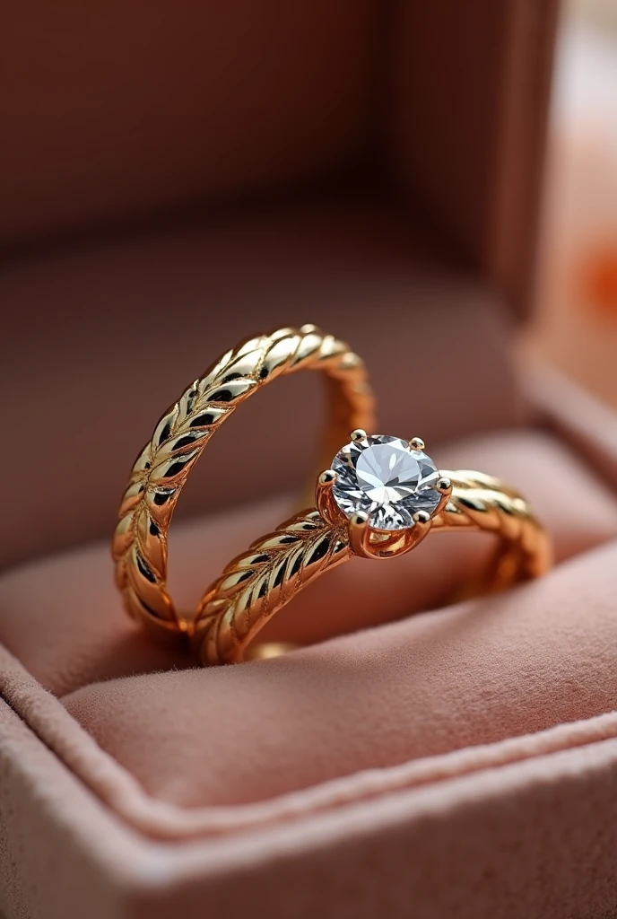 pair of wedding rings and engagement ring in gold color in a velvet box the men's ring is simple, only smooth and matching the women's ring in a soft braided pattern the women's ring has a brilliant minimalist diamond stone reminiscent of a flower with petals and around it a braided finish with small diamonds Inside the rings is written the word "AKAI TO"