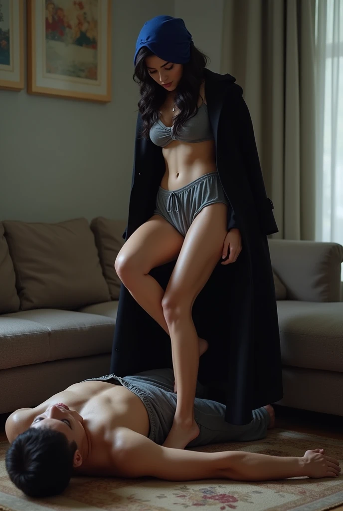Navy blue headscarf at home, Black long coat, barefoot, Sexy skinny woman. Man lying in front of woman. Woman puts her foot on the front of man's sweatpants.
