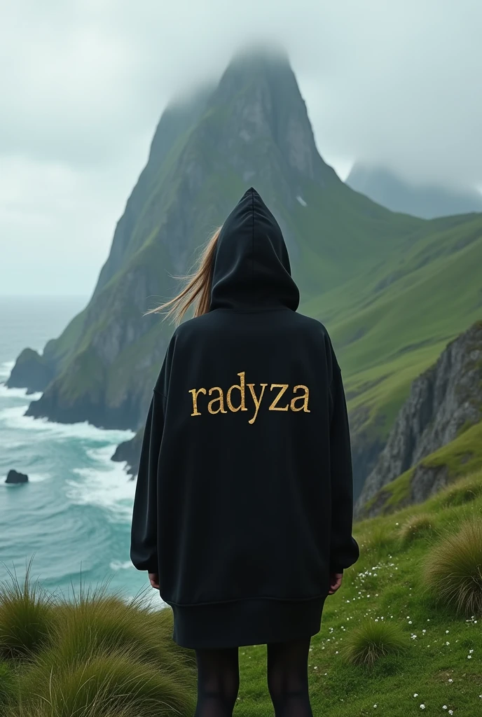 A woman stands on a plateau covered with lush green grass, her back facing the camera. He wore a black hoodie that contrasted with the natural surroundings. On the back of his hoodie, there is luxurious, shining gold writing that reads "RADYZA". The text stands out, as if exuding elegance amidst the serene landscape. In the distance stretches the vast sea with waves breaking on the rocks. You can see a tall mountain rising majestically, seen from the girl's perspective. At the foot of the mountain you can see standing firmly a line of vague sentences with the words "STARMAKER" in white, with letters designed with a horror theme, adding to the impression of mystery. The girl stared at the mountain in awe, while her arms stretched towards the sky, as if embracing the majesty of nature that lay before her.