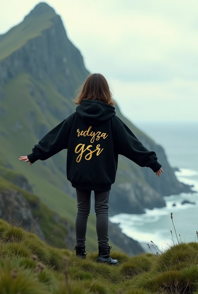 A girl stands on a hill covered with lush green grass, her back facing the camera. He wore a black hoodie that contrasted with the natural surroundings. On the back of his hoodie, there is luxurious, shining gold writing that reads "RADYZA GSR". (The text stands out, as if exuding elegance amidst the serene landscape). In the distance stretches the vast sea with waves breaking on the rocks. You can see a tall mountain rising majestically, seen from the girl's perspective. At the foot of the mountain, standing firmly, there is the writing "STARMAKER" in white, with letters designed with a horror theme, adding to the impression of mystery. The girl stared at the mountain in awe, while her arms stretched towards the sky, as if embracing the majesty of nature that lay before her.