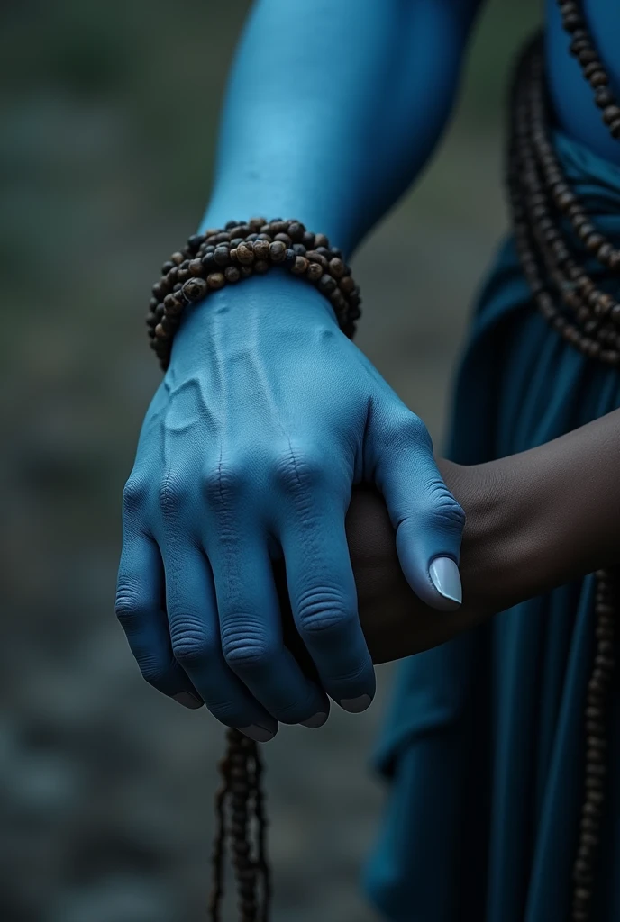 Aesthetic closeup photo of one hand of Shiva's blue hand having rudraksha maala around it grabbing eachother a 24 years indian male one hand with dark blur background. Image of a hand interlocked i.e. holding each other