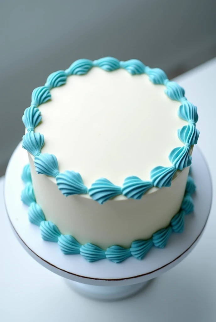 Create a cake with white frosting and blue and light blue borders