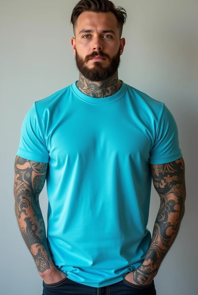 a real tattooed man standing with a turquoise blue t-shirt mockup