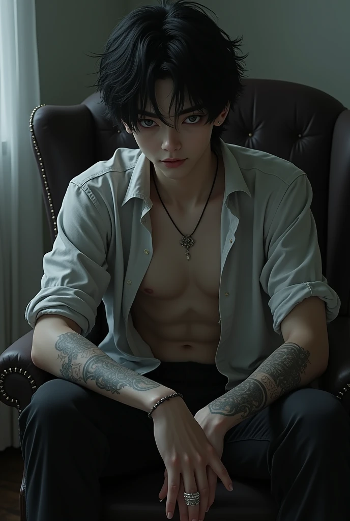 Far angle showing a black-haired boy with his arms full of tattoos and grey eyes, sitting on a chair half reclining, He has an open button-down shirt, one hand with three rings in her hair and the other is in her lap