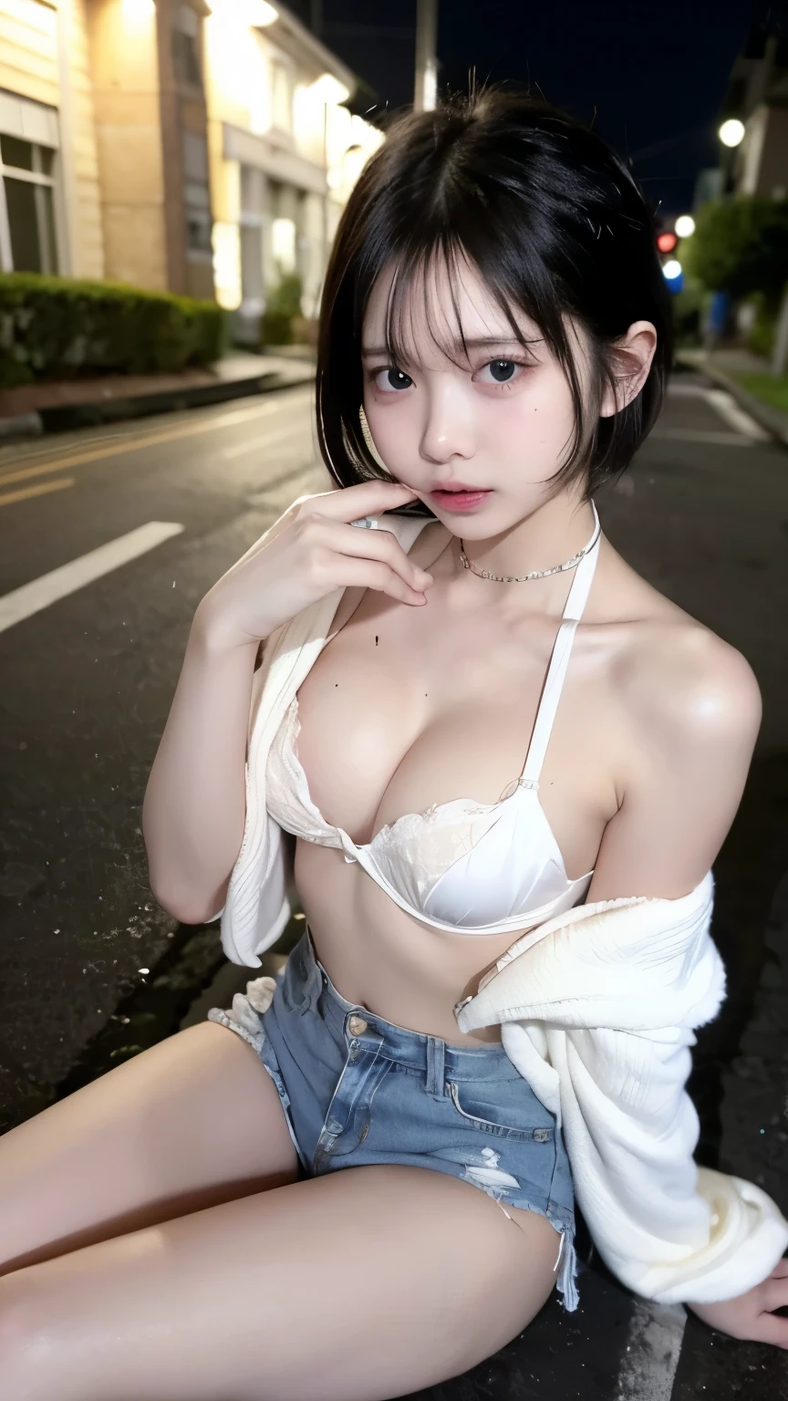 A young woman with messy open clothes sits on the side of the road at night. She wears a white bra and a messy open skirt revealing visible shorts. Her hair is disheveled, and tears stream down her face as she suckles on a baby pacifier.