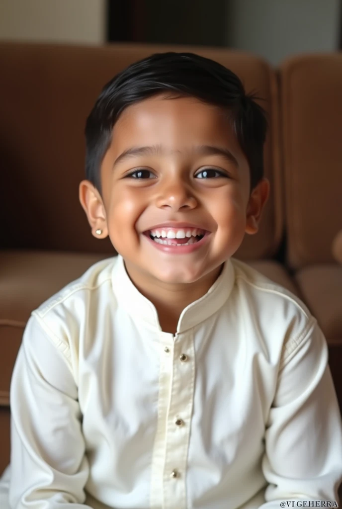 boy wearing kurta pajama white colour and setting on a sofa and smiling and too much too much gaps in him teeths also write Kherra in big letterss