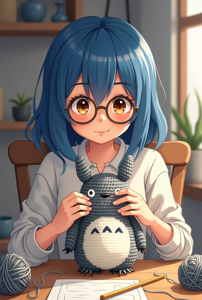 young woman with blue hair and brown eyes wearing glasses making a gray crochet totoro amigurumi cartoon drawing
