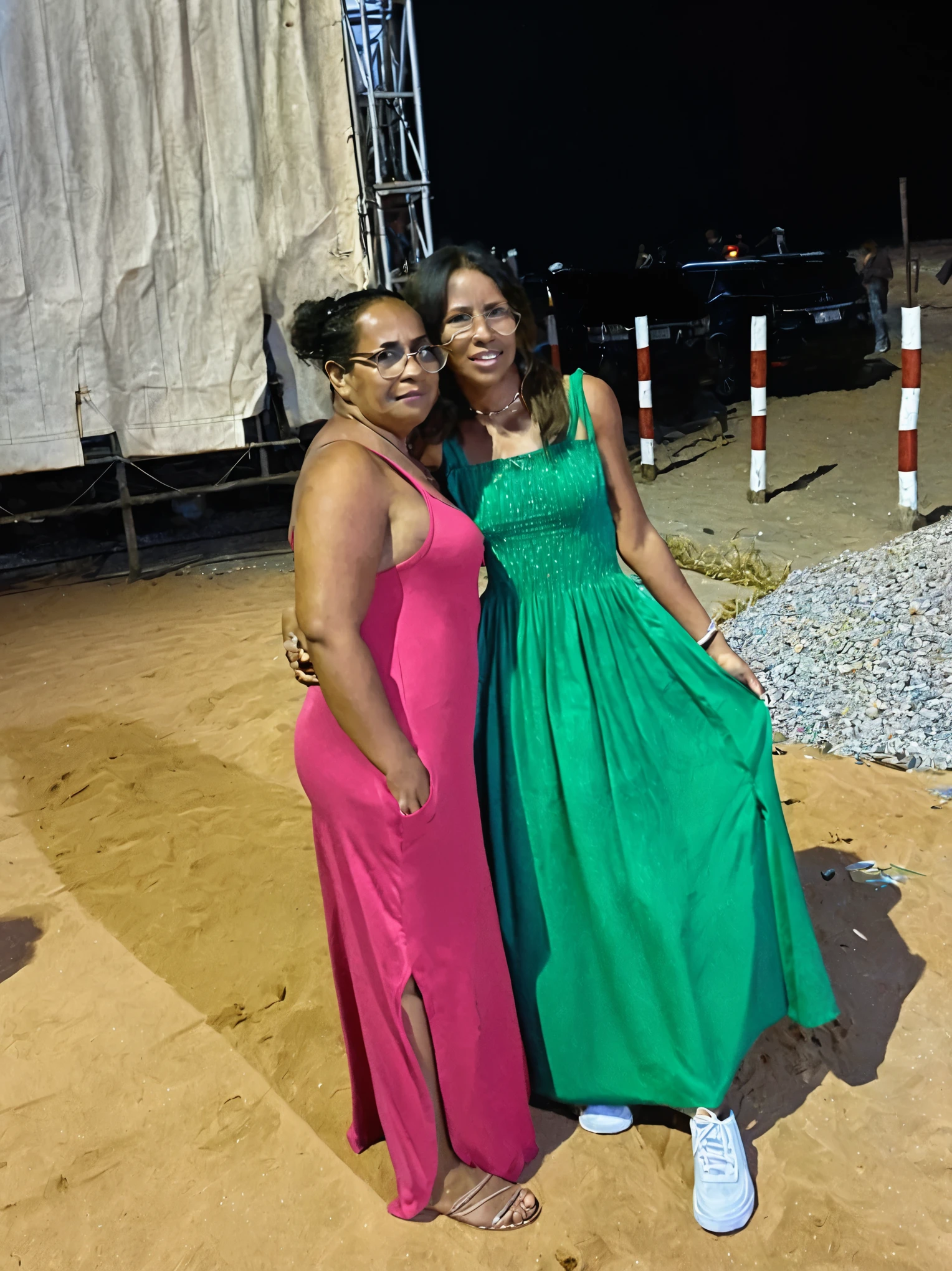 there are two women standing together in a field at night, close to the beach. disney pixar style 