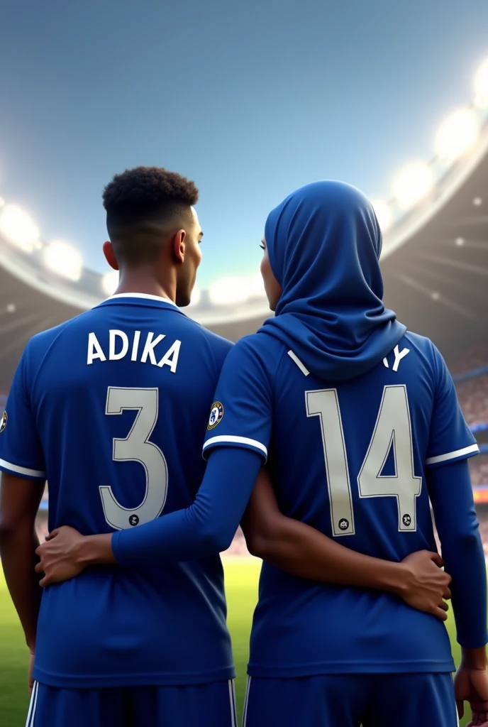 A man wearing a Chelsea uniform named ADIKA&#39;s back with a woman wearing a hijab wearing a Chelsea uniform named VICKY&#39;s back watching at the stadium