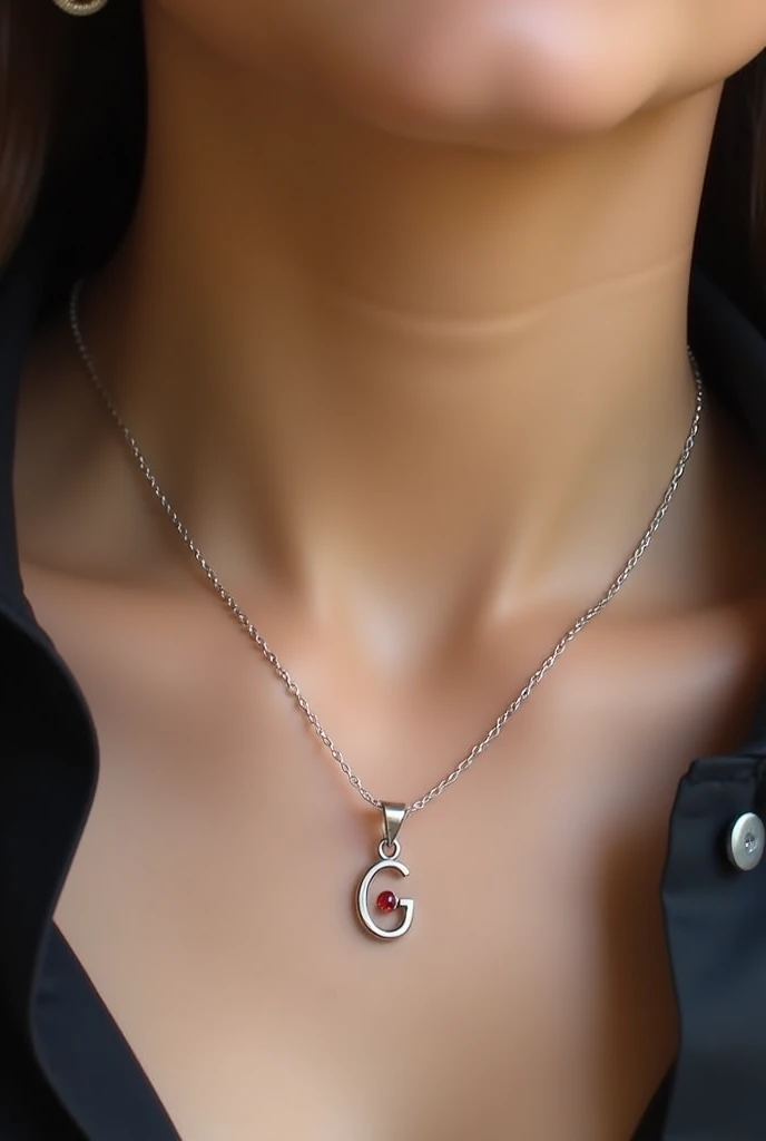 Silver necklace with a small oval-shaped initial G with a red pendant