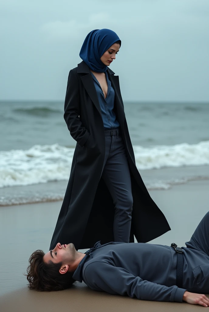 Navy blue headscarf on the beach, black long closed coat, barefoot, Sexy skinny woman. Man lying in front of woman. Woman puts her foot on the front of man&#39;s sweatpants. 