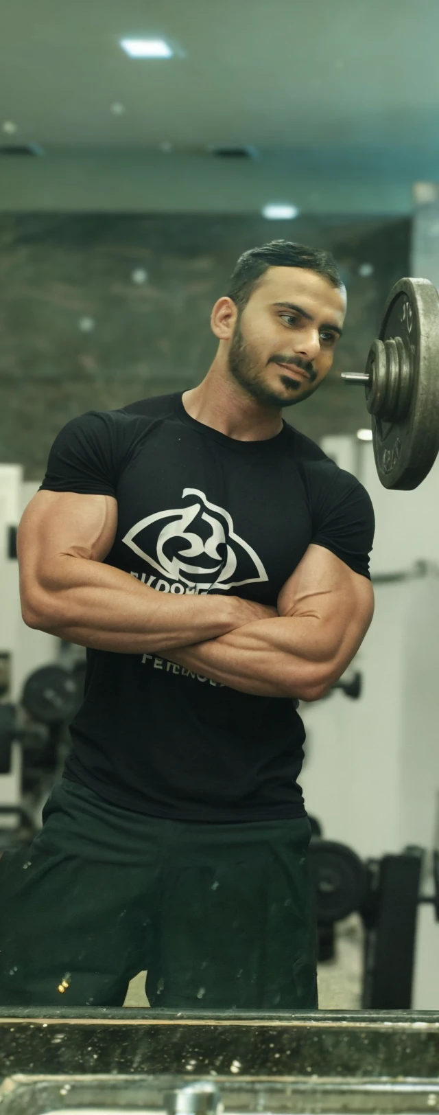 masterpiece, best quality, high resolution, realistic, handsome, photogenic, syahnk, SFW, a photo of a 35 year old gym frat (man:1.2) portrait, standing in a gym , military press, weights, stunning , short buzzcut hair,stubble head , (hypermuscle),looking at the viewer, flirting with the camera, charming, (tight white gym shirt ),(GS-Masculine:1), 8K UHD