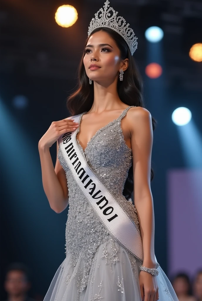 Photoshoot of miss Universe with silver Evening gown with silk shawl , crown and Sash. Black Background. Slim body, beautiful face.