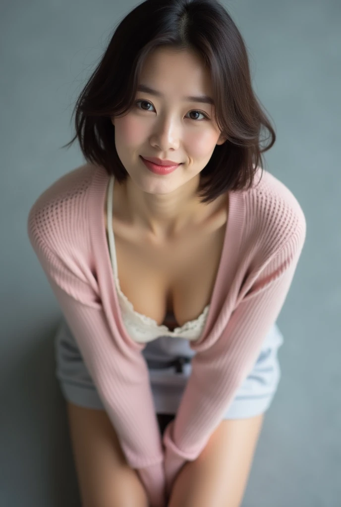 ((Highest quality, 8k, Portraiture: 1.3)), (Viewer Display), Photographic realism, Sharp focus, alone, A very beautiful Japanese office lady、Denim mini skirt、 (Dark pink V-neck sweater、Deep neckline),White bra、evil grin、smiling at viewer、short hair、Gray background、Leaning forward、Front Light、Bend your body,front,top-down view、down blouse, ((Cleavage)),