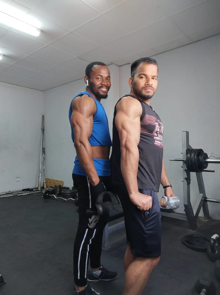 Muscular white man next to a weak black guy
