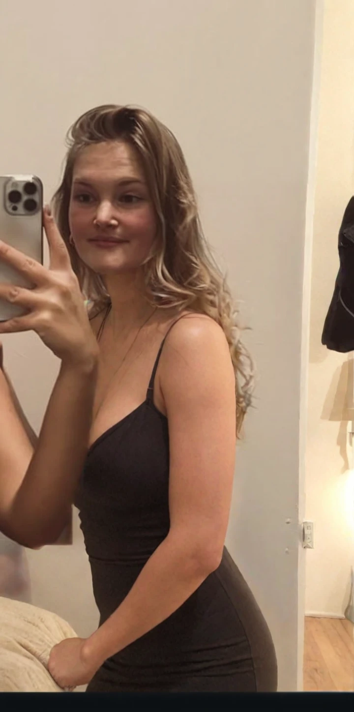 Cute girl in changing room trying on new clothes naked