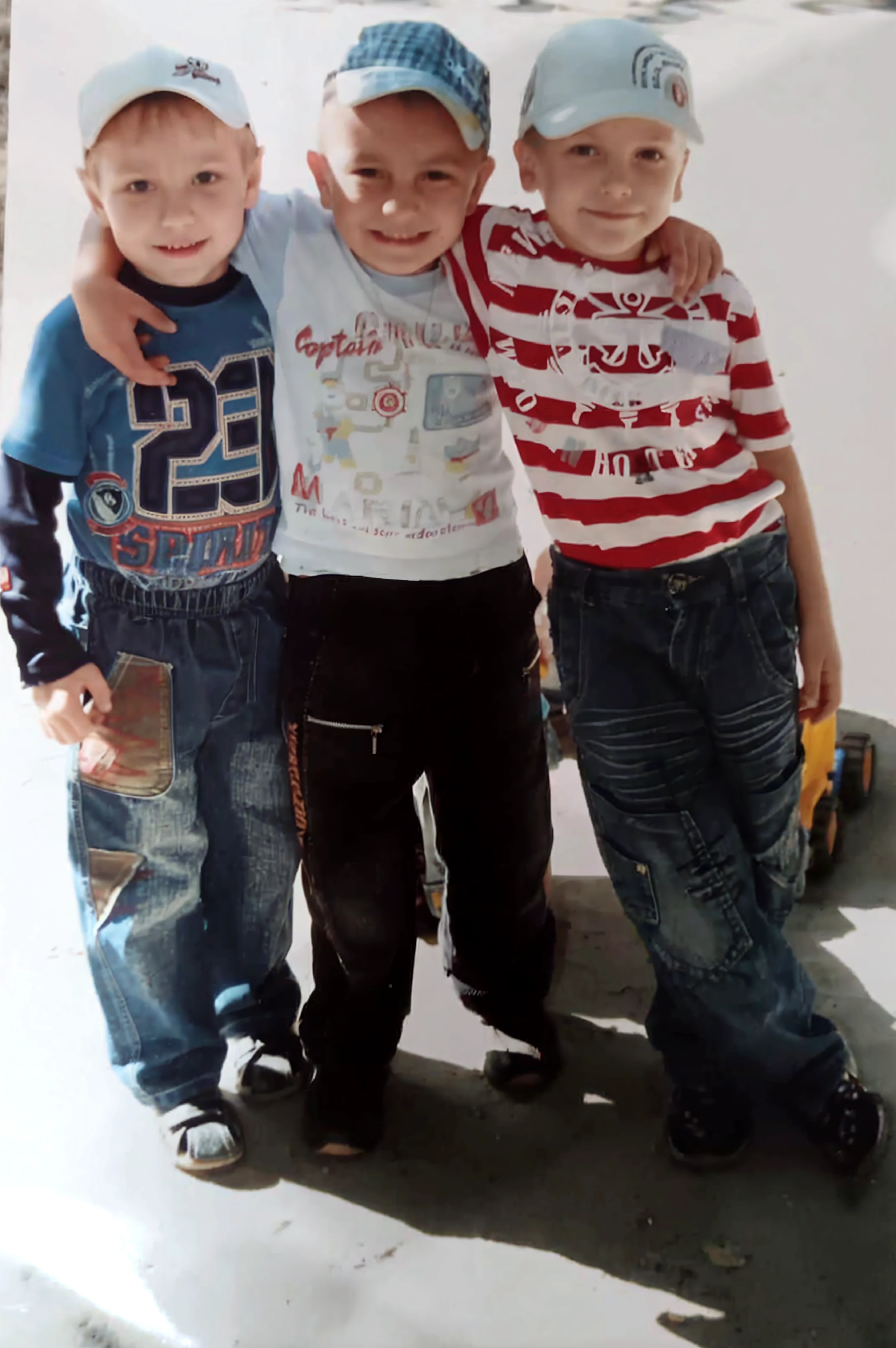 a spoiled child who hits and hurts people in the street.  his mom and his big brothers are laughing and in their hands are clapperboards.