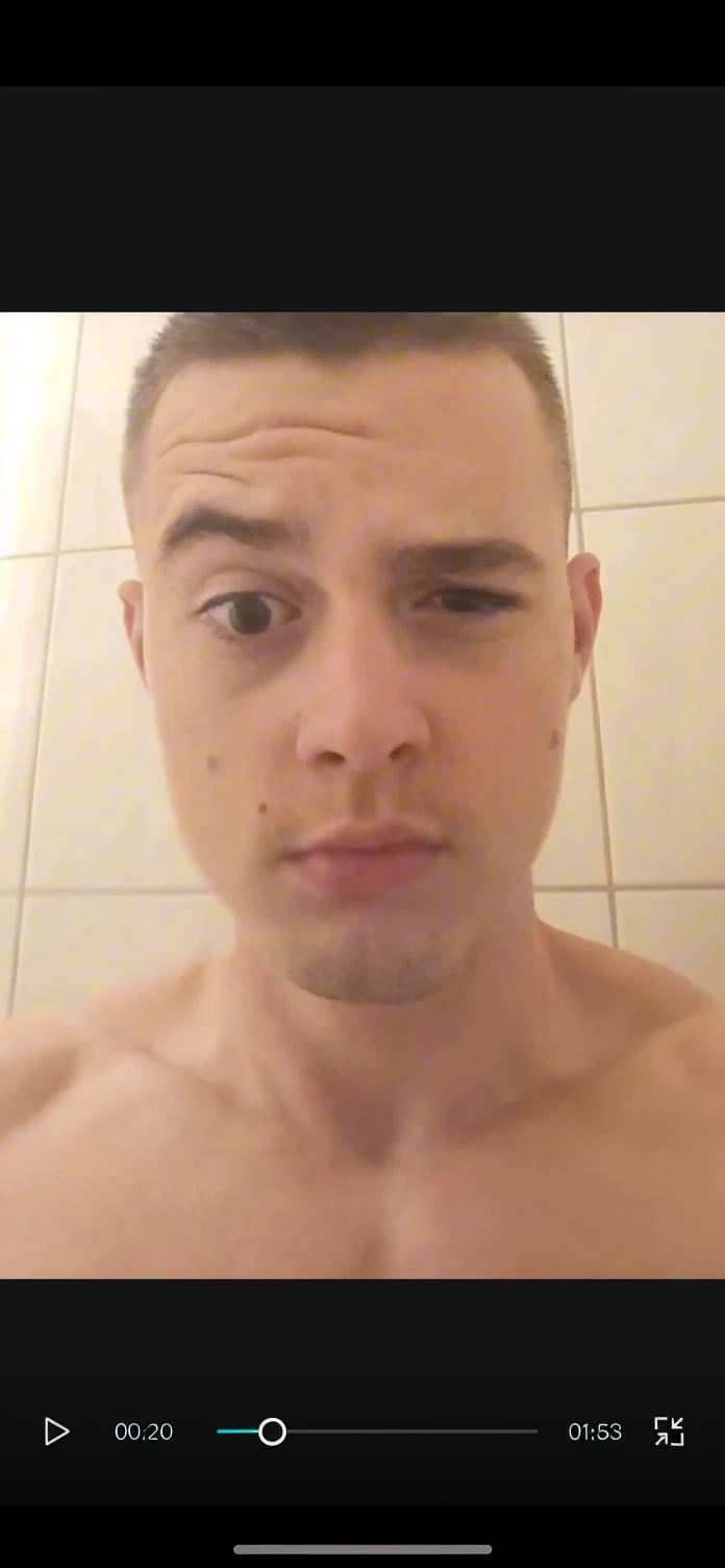 , in the shower, naked, leaning forward, natural breasts, pink hair, pink vagina, dim lighting, straight hair. He was shot from the ground up, leaning over the camera. 200 bra size breast