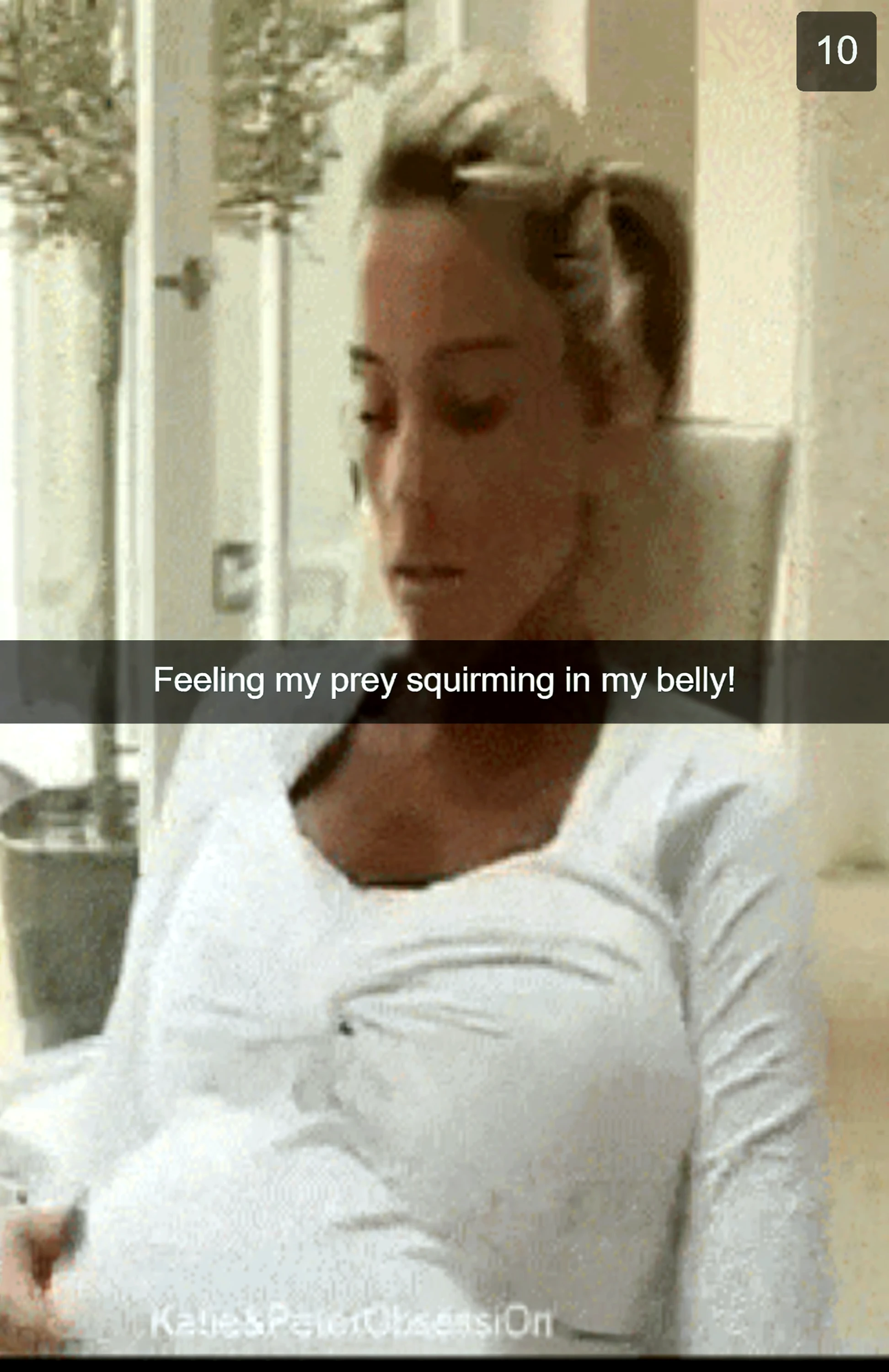 a pregnant woman in a bathroom in a bathtub with her face showing pain