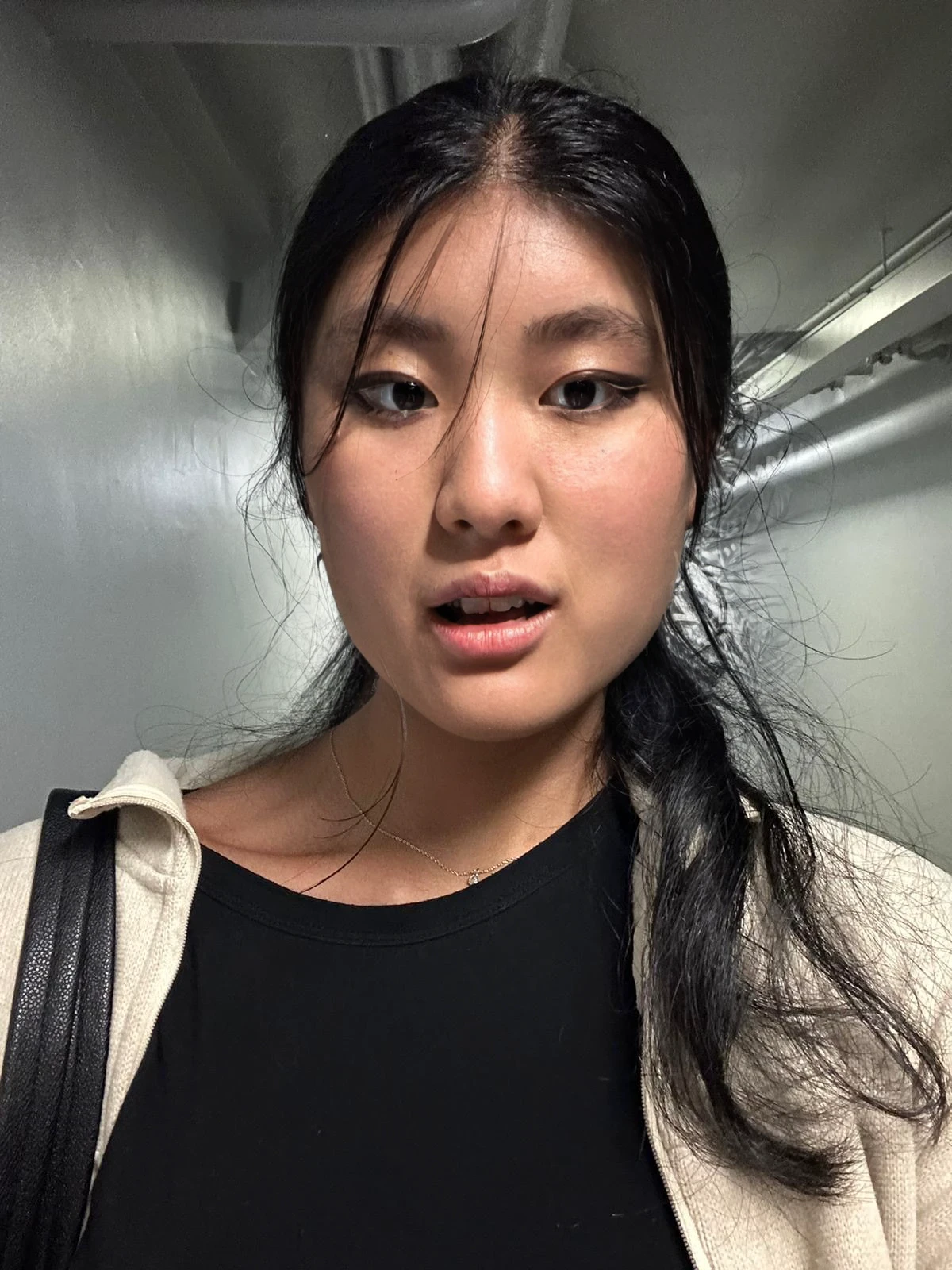 There is a woman sitting on a bench with a bag on her shoulder, Pouting, Asian Face, asian female, asian female, a young asian woman, Scared face, shocked expression on her face, with a sad expression, young cute wan asian face, she has a distant expression, south east asian with round face, youtube video screenshot, Her face hurts