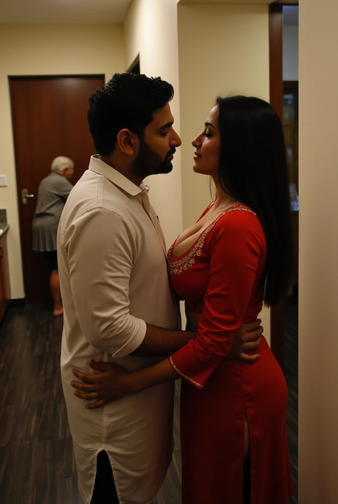 A day time scene in a well lit space captures a short young indian man and a woman in the foreground obscured from the individual in the background, emphasizing the separation of spaces within the kitchen. Behind the kitchen doorway, slightly to the left, the man and woman stand close together, ensuring they remain out of sight from the old lady standing at the kitchen sink washing dishes with her back to the camera. The man is positioned slightly to the side, turning his body toward the woman in front of him, who stands directly facing him. She is dressed in a body hugging kurti hugging her Large breasts that dominate her upper body frame by stretching outward in an exaggerated manner with the rest of her body appearing much slimmer by comparison. The kurti (tunic)  is fitted and features three-quarter sleeves with detailing at the hemline. The neckline is cut in a deep U-shape wide scoop, revealing her deep tantalising cleavage. Their bodies are almost touching, creating an intimate connection between them. He looks downward at her, while she tilts her head upward to meet his gaze. 
The lighting is volumetric, encapsulating the interaction between the two people while the third person continues her task, completely unaware of the intimacy unfolding just outside the kitchen.