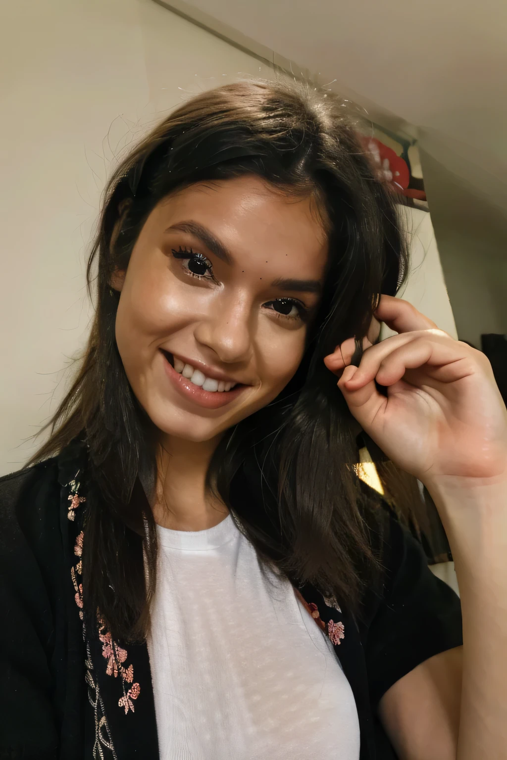 A woman smiling, eye level camera, with hand on face