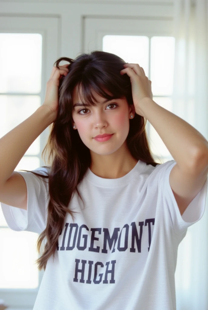 This film photograph captures a young woman named phoebe with fair skin and a slim physique. She has long, wavy brown hair that cascades down her back, partially pulled up with her hands behind her head. Her facial features are delicate, with high cheekbones, full lips, and a slightly rounded jawline. She has expressive brown eyes accentuated with subtle makeup, including a touch of pink lipstick and light eyeshadow. She is wearing a loose-fitting white t-shirt with a prominent bold text that reads "RIDGEMONT HIGH" centered on the chest, suggesting a casual outfit. The shirt appears to be made of soft, cotton fabric, and the texture of the material is visible, adding a sense of comfort and ease. The background features large, white-framed windows that allow natural light to flood the room, creating a bright and airy atmosphere. The windows are partially covered by sheer white curtains, adding a soft, diffused effect to the overall scene. The image is sharp and clear, with a focus on the subject, highlighting her youthful and confident demeanor. The overall aesthetic is modern and minimalistic, emphasizing the subject's natural beauty and the simplicity of the setting. 