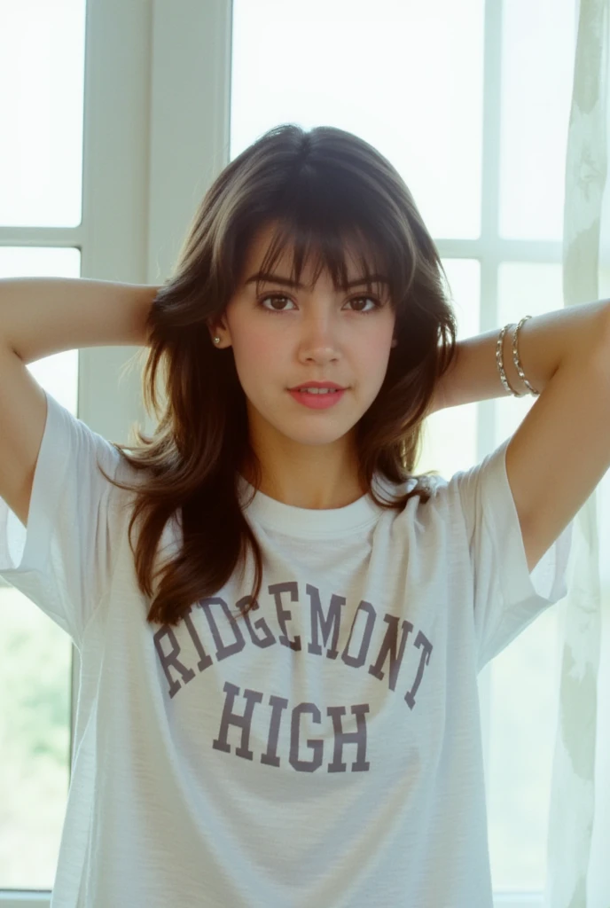 This film photograph captures a young woman named phoebe with fair skin and a slim physique. She has long, wavy brown hair that cascades down her back, partially pulled up with her hands behind her head. Her facial features are delicate, with high cheekbones, full lips, and a slightly rounded jawline. She has expressive brown eyes accentuated with subtle makeup, including a touch of pink lipstick and light eyeshadow. She is wearing a loose-fitting white t-shirt with a prominent bold text that reads "RIDGEMONT HIGH" centered on the chest, suggesting a casual outfit. The shirt appears to be made of soft, cotton fabric, and the texture of the material is visible, adding a sense of comfort and ease. The background features large, white-framed windows that allow natural light to flood the room, creating a bright and airy atmosphere. The windows are partially covered by sheer white curtains, adding a soft, diffused effect to the overall scene. The image is sharp and clear, with a focus on the subject, highlighting her youthful and confident demeanor. The overall aesthetic is modern and minimalistic, emphasizing the subject's natural beauty and the simplicity of the setting. 