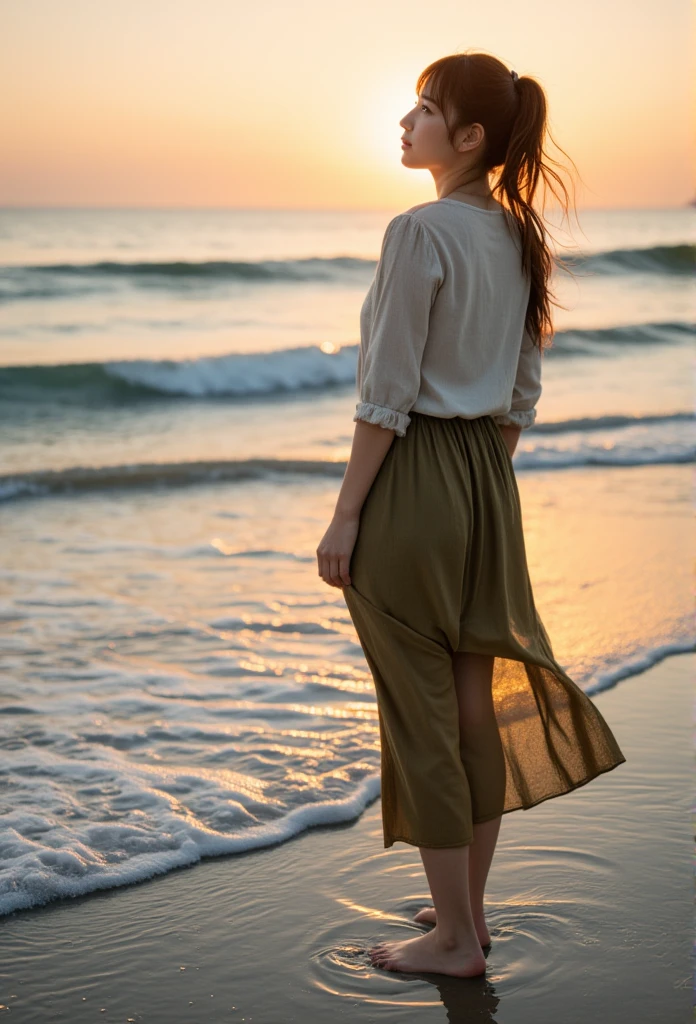 A serene scene at the beach during sunset, capturing a young slender asian woman standing barefoot on the wet sand near the edge of the ocean. The woman has long, loosely tied brown hair flowing slightly in the wind. She wears a classic, slightly worn-out light blouse and an olive-green skirt that reaches her knees, with the fabric catching the golden sunlight. Her right hand delicately holds the edge of her skirt, lifting it slightly as she gazes toward the distant horizon with a calm expression. The ocean waves are gentle, with ripples and foam illuminated by the warm, amber glow of the setting sun. The overall atmosphere is tranquil, with soft, muted tones and a painterly texture. The composition highlights the balance of light and shadow, especially on the wet sand where reflections of the sky and the woman are visible.