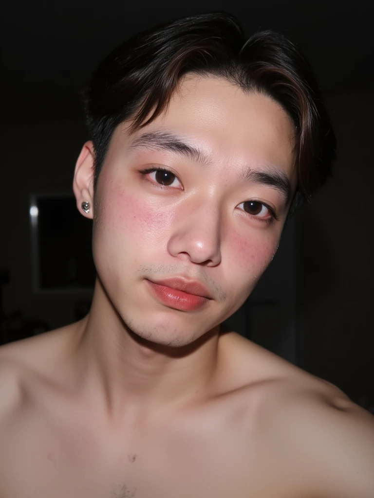 The image is a close-up photograph of a young Asian man with a fair complexion. His face is covered in male semen. He is indifferent about the male semen on his face. The semen is on his most predominant features like his nose, lips, and pecs, His face dominates the frame, occupying the majority of the image, with his eyes, nose, and lips prominently visible. He has large, almond-shaped eyes with long, thick eyelashes, and his skin is smooth and soft. His lips are full and slightly parted, revealing a natural, rosy hue. He wears a silver stud earring in his left ear, adding a subtle touch of personal style. His hair is short, dark brown with subtle highlights, and it partially covers his forehead, giving a slightly tousled, casual look. The background is out of focus, but it appears to be a dark, possibly indoor setting, which emphasizes his face and provides a stark contrast to his light complexion. He is wearing no shirt, and has a muscular figure with large pecs which is visible at the bottom of the image. The overall mood of the photograph is intimate and personal, capturing a candid moment with a natural, unfiltered aesthetic. His face is covered in male semen. He is indifferent about the male semen on his face. The semen is on his most predominant features like his nose, lips, and pecs,
