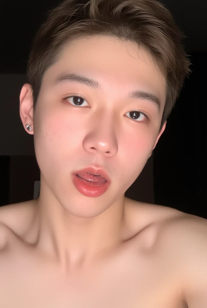 The image is a close up casual selfie of a young asian man that recently got cummed on by a guy. his face is squirted with white male semen. he is indifferent about the white male semen dripping down his face. He has large,almond-shaped eyes with long,thick eyelashes,and his skin is smooth and soft. He has some facial hair growing in. His lips are full and slightly parted,revealing a natural,rosy hue. He wears a silver stud earring in his left ear,adding a subtle touch of personal style. His hair is short,dark brown with subtle highlights,and it partially covers his forehead,giving a slightly tousled,casual look. The background is out of focus,but it appears to be a dark,possibly indoor setting,which emphasizes his face and provides a stark contrast to his light complexion. He is wearing no shirt,and has a muscular figure with large pecs which is visible at the bottom of the image. The overall mood of the photograph is intimate and personal,capturing a candid moment with a natural,unfiltered aesthetic. Translucent cum, nsfw, racy image,