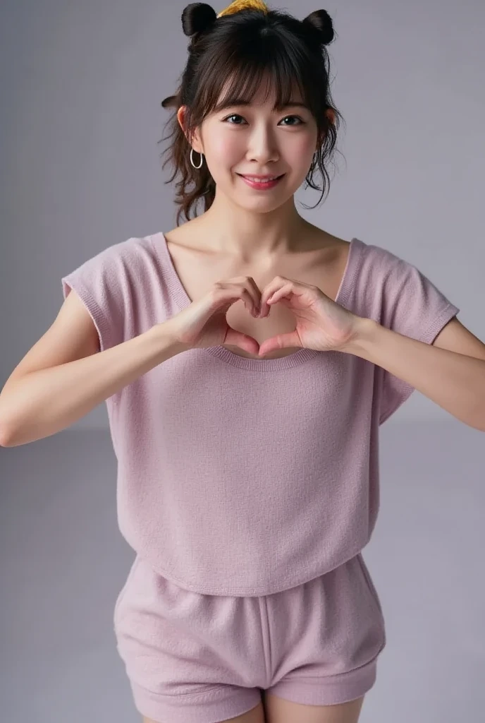 Only one woman with a cute smile is in a pose wearing off-shoulder pajamas, making a firm big heart shape with both hands, and holding them in front of her chest, View above collarbone、The background is a monotone 

